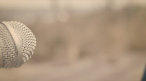 Woman singing into a microphone closeup - Free Stock Video