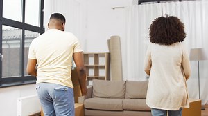 couple-moving-to-new-home-hugging-and-kissing-9L5M2ES