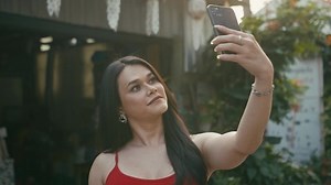 a beautiful trans woman takes selfies walking down the street