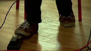 Musician pressure pedal with foot and take a rhythm at concert