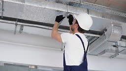 Hvac worker install ducted pipe system for ventilation and air...