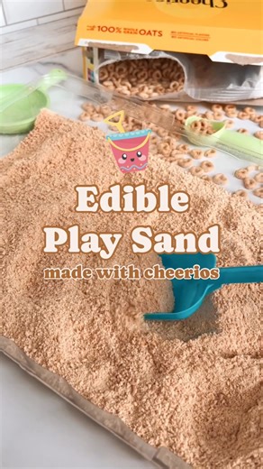 Edible play sand...made with Cheerios!! 🤩⛱🪣 This edible play sand is the hit of the summer so far in our house! My girls have played NICELY together with it non-stop for the past 2 days! They haven't even asked for tablet time...gasp!! All you need is a box of plain Cheerios and a blender and you can whip up a batch of this Cheerio play sand in a couple minutes. This one is a winner!! #sensoryplay #playsand #sandbox #kidsactivities | The Soccer Mom Blog - Positive Inspiration for Moms