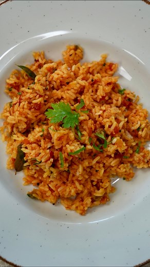 Tomato rice 🍅 INGREDIENTS * Rice-1 cup (uncooked) * Ghee-1 tbsp * Mustard seeds-1/2 tsp * Chana dal-1 tsp * Urad dal-1 tsp * Crushed garlic 🧄-4-5 cloves * Chopped green chilli-2 nos * Curry leaves-1 sprig * Chopped onions 🧅-1 medium sized * Chopped tomatoes 🍅-2 medium sized * Tomatoes puree -1 nos medium sized * Ginger garlic paste-1tsp * Salt * Turmeric powder-1/2 tsp * Kashmiri chilli powder-1 tbsp * Chopped coriander leaves for garnish METHOD * Wash and soak the rice for 30 minutes and bo
