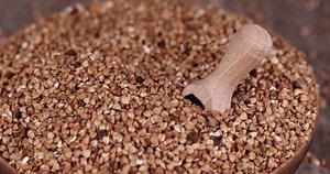 a large amount of low-quality processing of buckwheat groats close-up, Poorly cleaned buckwheat groats for cooking porridge