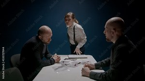 Police detective shows suspected criminal knife in blood in Evidence bag. Interrogation. FBI agents force criminal in handcuffs to confess to murder. Law justice. Photo from crime scene. Russian mafia