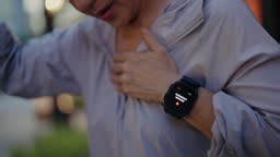Senior woman having heart attack while running. His smartwatch...