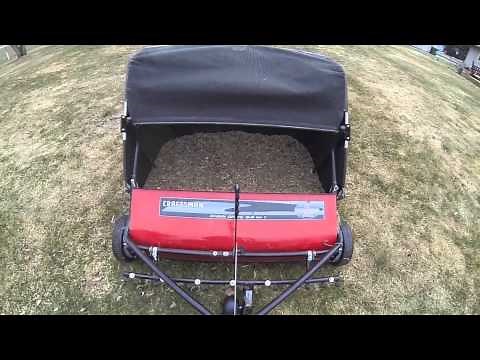 Craftsman lawn sweeper dethatching lawn towed by John Deere X300