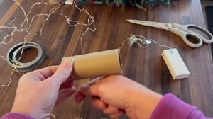 She wraps string lights around a paper towel tube for this brilliant hack!