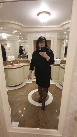 elegant crossdresser Christina d'Yvon in black satin blouse, pencil skirt and high heeld