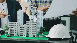 Download Homeowners and foreman signing contract at construction site for free