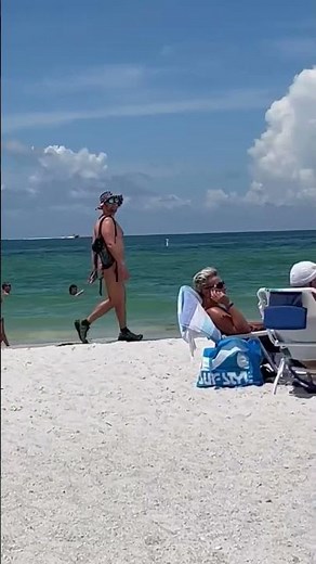 Bold guy struts in thong g-string on the beach