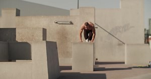 Male athlete leaping over barrier