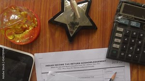 Close up of Indian Income tax return form ITR-2 return form is on the table next to a pen, calculator and a home mortgage loan application form placed on the desk. Financial Business concept.