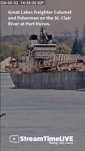 Great Lakes freighter Calumet and fisherman on the St. Clair River at Port Huron.