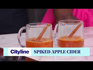 Spiked warm apple cider drink with cinnamon