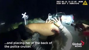 Train slams into police car with woman handcuffed inside, shocking video shows