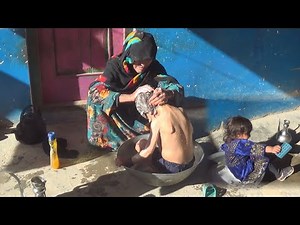 Bathing village children by grandmother