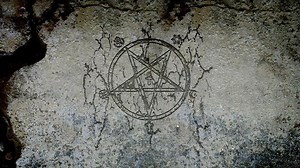 Evil symbol appearing on a wall