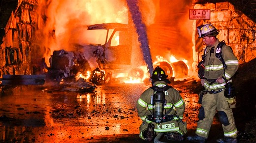 Truck carrying gas hits railroad bridge and explodes as a train passes overhead
