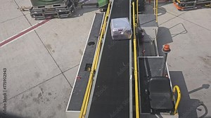 Loading luggage on the plane. The baggage on the conveyor belt to the airplane.