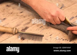 Beautiful female furrier crafting mink fur coats in traditional workshop studio