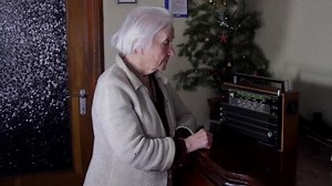 99 Years Old Woman Turning The Buttons Of An Old Radio And Listening