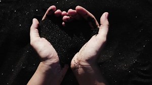 clip-1012435613-beautiful-black-sand-female-hands