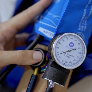 Measuring blood pressure at clinic front desk. Health care equipment. Consultation at clinic. Pressure measuring device. Selective focus on hand | Premium Stock Video Footage
