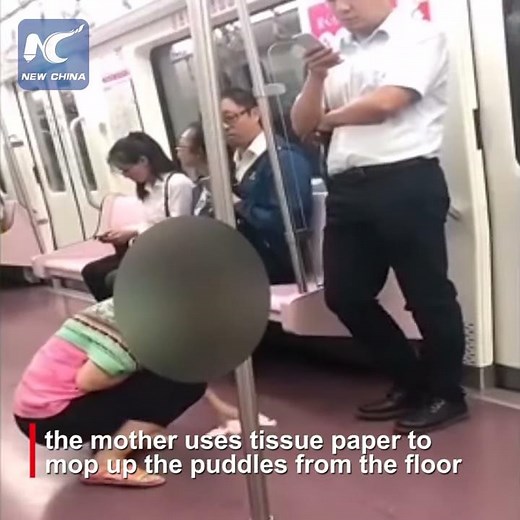 Baby pees on subway, mother cleans with tissue paper