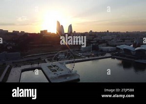 Baku, Azerbaijan - June 27, 2023: Drone footage taken at sunset, showing the magnificent Crescent Hotel and surrounding skyscrapers, with a backdrop