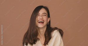 Amazed excited woman hairstyle in beige shirt open face in surprise looking at camera with big eyes, shocked. Indoor studio shot isolated on beige background. Oh my god wow! Wow, it is awesome.