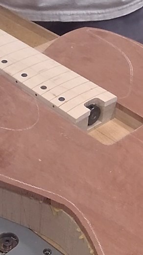 Routing the neck pocket. Using a center finding rule, I line up the neck with the body centerline. Then I’ll add some MDF cutoff pieces used to create a makeshift template, and glue them down using masking tape and CA glue. I used to make a set template for this, but I’m finding this method to be easier and more versatile. Then go to town with your router and as always, check your fit. . . . #guitars #luthier #guitarmaker #luthiery #guitarneckpocket #luthiers #guitar #electricguitar #arizona #ha