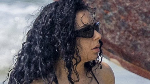 Charli XCX is every inch the beach babe as she flaunts her sensational figure in a G-string bikini in Australia