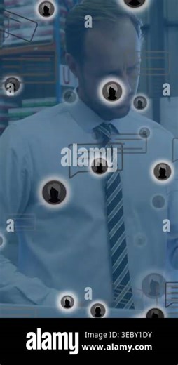 Adult man in shirt and tie at workstation near racks tracking incoming icons while checking laptop. Warehouse, augmentedreality, interface, overlay, supervisor, logistics, vertical video Stock Video Footage - Alamy