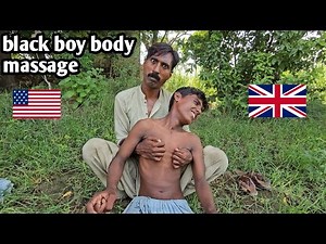 A little black boy getting full body massage from brother