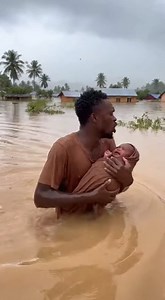 271K views · 16K reactions | A young African man wading through chest deep muddy floodwaters in a rural villag | Tusiime orphanage care center | Facebook