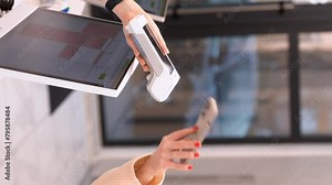 Pay by phone on electronic payment machine or card reader. E-money at cashless wallet. Female hand with pos-terminal and cellphone closeup. 4k vertical shot Stock Video