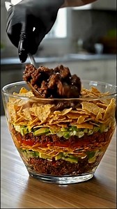 34K views · 242 reactions | Seven-Layer Taco Salad Showstopper A bold, colorful party bowl stacked with classic taco layers in every scoop. Ingredients : ...... Full Recipe in Coʍmеոτ  | CookFrontier by Sierra | Facebook