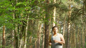 Free stock video - Curvy woman running in the forest