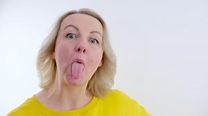 tease disagree woman sticks out tongue Then laughs sticks out eyes make faces tired of talking childish teenage behavior of adult woman psychology analysis of occupation easy person Cheerful joyful