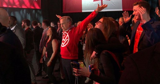 Mark Carney dances with supporters to celebrate his election victory