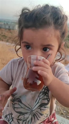 Charming Child Enjoying a Refreshing Drink Outdoors