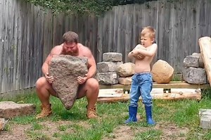 Caveman workout: Father and son lift rocks together