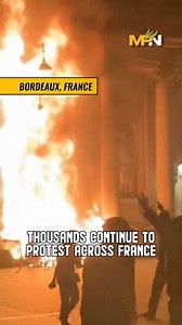 French protesters set fire to the town hall in Bordeaux on Thursday evening during protests against the retirement age increase forced through by Macron last week. Thousands continue to protest his policies across France. | MintPress News