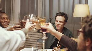 clip-1054466213-young-handsome-man-smiling-giving-toast-clinking