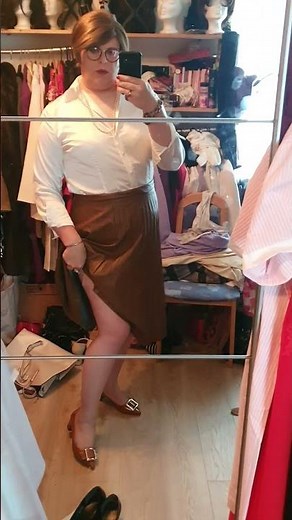 elegant crossdresser, white silk blouse and pleated skirt. mtf boy to girl