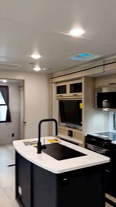 Voyage 3538BR: Front true queen bed floorplan with a spacious bathroom, theater seating and dinette in one slideout, an entertainment center and large galley in the opposing slideout, a large bunkhouse with additional bunk above tri-fold sofa in the rear slideout, and an outdoor kitchen. | Winnebago