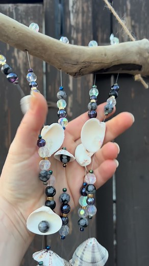 Sea shell wind chime 🐚💜 Created with snowflake gemstone, faceted crystal beads and shimmering dark purple beads. This piece sparkles in the sunlight and sounds beautiful in the breeze. It can be displayed indoors or outdoors ! On sale for $23.00 Local pickup / delivery available in #reddeer Order online ⬇️⬇️ https://sandandseacanada.etsy.com $38.40 with shipping included - Tracked package #windchime #seashells #handmade #christmasgiftidea #secretsanta | Sand & Sea Creations