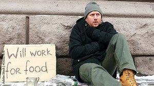 4K. Adult hungry despair man looks for work on city street. Approach of focus