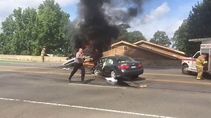 FIERY WRECK Emergency responders scramble around the scene of a burning, overturned vehicle in the 5100 block of Central Avenue earlier this morning. Two vehicles collided, and one overturned and caught fire. At least one person was transported to a local hospital. Video by Richard Rasmussen of The Sentinel-Record. | The Sentinel-Record